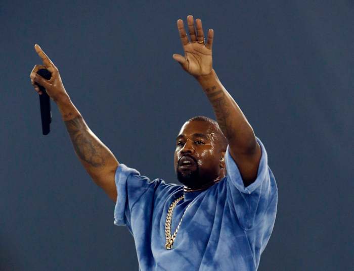 Kanye West performs during a concert.